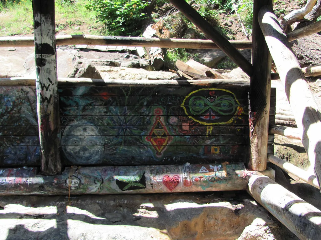 Graffiti around covered pool at Umpqua Hot Springs, Oregon